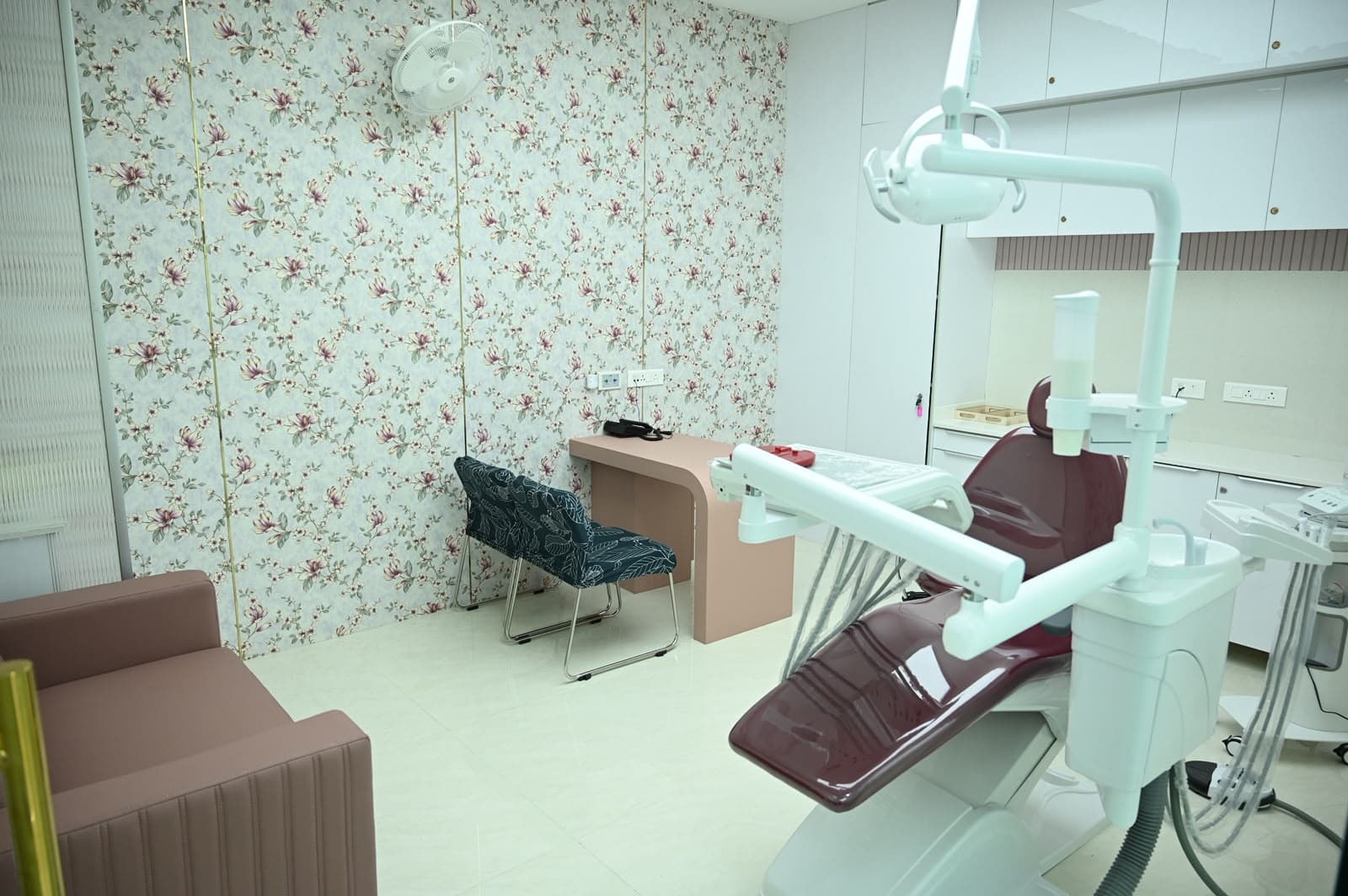 Cabin 3 with a maroon chair and floral wallpaper